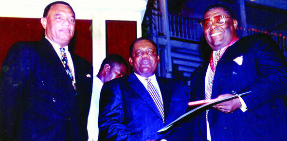 Kenneth Francis C. B. E.  recieving an award from Former Prime Minister Rt. Hon. Hubert Ingraham at the 25th Anniversay of independence. Current Prime Minister Rt. Hon. Perry G. Christie looks on.
