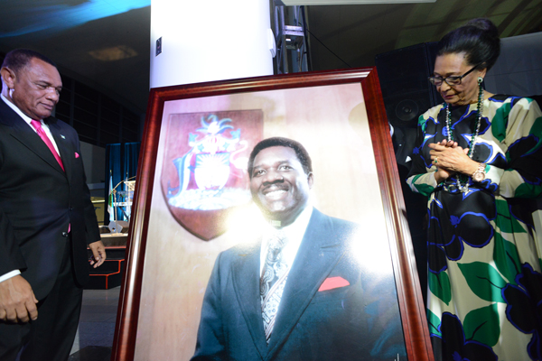 Prime Minister Perry Christie and Dame Marguerite Pindling, wife of Sir Lynden Oscar Pindling, former Prime Minister of The Bahamas, unveils a photo of Sir Lynden at the official opening ceremony of the Domestic Arrivals and Departures and International Departures Terminal, for whom Lynden Pindling International Airport is named.