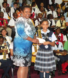 Kaitlyn Francis receiving her awards from Mrs. Tabitha Newbold, CIBC FirstCaribbean Branch Manager, Marathon Mall Branch 