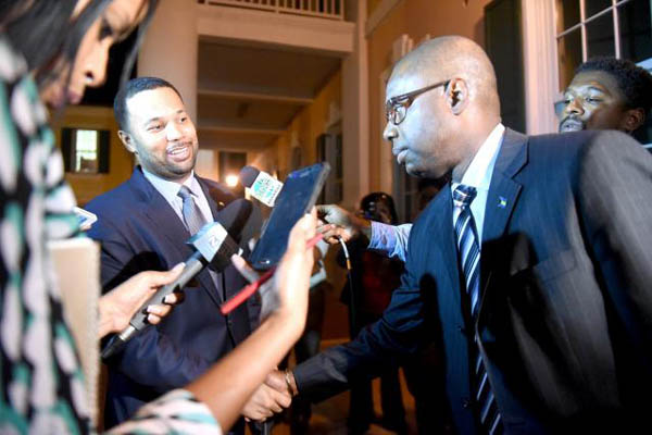 Speaker of the House Kendall Major congratulating Andre Rollins outside the House following his resignation from the PLP. Major is in on the new transition. See ya on the next side.