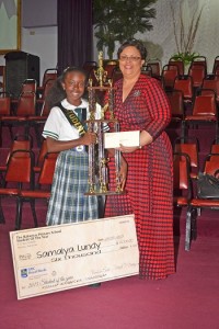 Mrs. Deborah Zonicle, RBC Royal Bank of Canada, Manager of Product Channels and Marketing, The Bahamas, Turks & Caicos Island and Cayman presenting Samaiya Lundy with her $6,000.00 Scholarship for high school