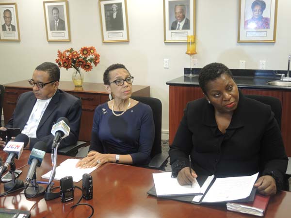Attorney General and Minister of Legal Affairs, the Hon. Allyson Maynard-Gibson, center, is pictured answering questions from the media during a press conference at the Ministry of Legal Affairs on Thursday afternoon. The Minister put forth the policy of the government of The Bahamas regarding the Baha Mar bankruptcy filing on the 29th June 2015 in a Delaware court. To her left is the State Minister for Legal Affairs, the Hon. Damian Gomez and to her right is the Director of Legal Affairs, Ms. Antoinette Bonamy.  