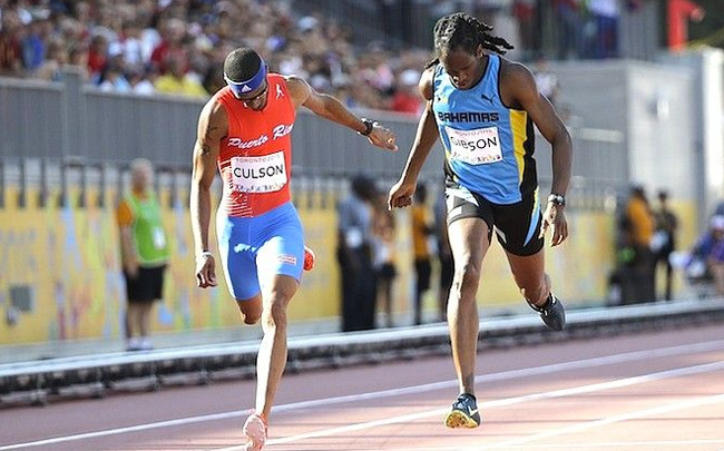 Jeffery Gibson, right, and Puerto Rico’s Javier Culson cross the line in the men's 400 meter hurdles final at the Pan Am Games. (AP Photo)