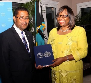 Minister of Health the Hon. Dr. Perry Gomez accepts national award from PAHO/WHO Director Dr. Carissa Etienne, celebrating the Elimination of Measles in the Region of the Americas. (BIS Photo/Patrick Hanna) 