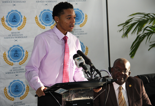 The 2015 All-Bahamas Merit Scholar, Domonic McDonald’s response of gratitude for receiving the most coveted award for high school students in the country. Pictured looking on is Reginald Saunders, Administrator Scholarships and Loan Division, Ministry of Education Science and Technology. The awards ceremony was held on Wednesday, August 12, 2105 at the Thomas A. Robinson National Stadium. (BIS Photo/Patrick Hanna).