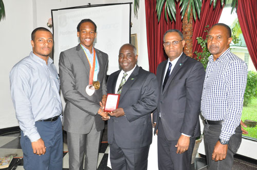 TOKEN OF APPRECIATION -- Deputy Prime Minister and Minister of Works and Development was presented with a plaque by Bahamian track sensation, Jeffrey Gibson during the 2015 GB Annual Meeting and Workshop Luncheon at Ruby Swiss Restaurant on Thursday. Shown from left are: Remington Wilchcombe, President of the Northern Branch of the Bahamas Society of Engineers; Jeffrey Gibson; Deputy Prime Minister Davis; Minister for Grand Bahama, the Hon. Dr. Michael Darville; and DeCosta Bethel, National President of the Bahamas Society of Engineers. (BIS Photo/Andrew Miller)