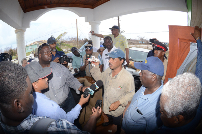 Michael Carroll of Landrail Point recalls the hurricane as DPM. Davis and Minister B.J. Nottage 