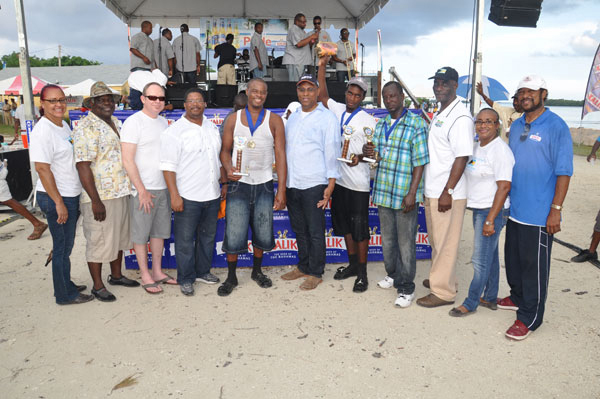 TROPHY PRESENTATION – With the 43rd annual Conch Cracking Competition concluded, the trophy presentation took place in McLean’s Town on Monday. Shown from left are: Zestina Nixon, Ministry of Tourism; Kenneth Russell, former MP for High Rock, and one of the judges; Buzz Cox, Deep Water Cay; Peter Turnquest, Deputy Leader of the FNM and MP for East Grand Bahama, and another judge for the competition; Joseph Tate, 1st place winner; Minister for Grand Bahama, the Hon. Dr. Michael Darville; Robert Tate, 2nd place winner; Cardinal McIntosh, 3rd place winner; Harrison Thompson, Permanent Secretary for the Ministry of Tourism, and the third judge; Elaine Smith, Ministry of Tourism; and Clement Knowles, Burns House. (BIS Photo/Vandyke Hepburn) 