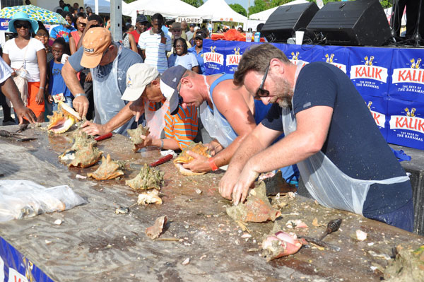 VISITORS GET A TURN – Residents of Grand Bahama were not the only ones taking part in the 43rd annual Conch Cracking Competition. Shown are some of the visitors who did their best to remove the conch from the shells during the event on Monday in McLean’s Town. (BIS Photo/Vandyke Hepburn)