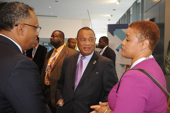 Ministers Strachan and Darville engaged in conversation with Prime Minister 