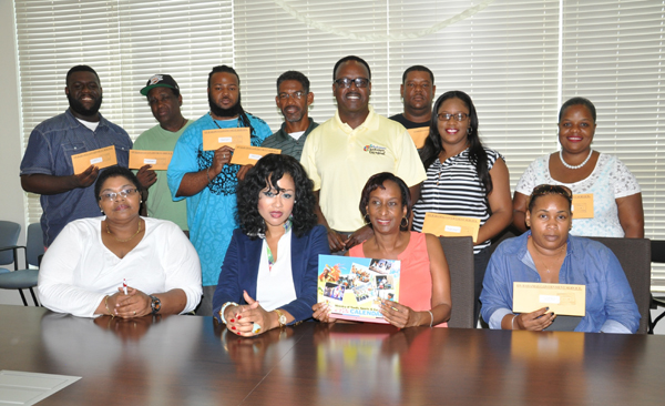 SENIOR GROUPS RECEIVE FUNDING - Senior Junkanoo groups received their seed money on Saturday during a cheque presentation at the Ministry of Youth, Sports and Culture. Dr. the Hon. Daniel Johnson, the Minister responsible was on hand to meet with the various groups and organizations involved. Minister Johnson (standing centre) is seen with Junkanoo group members along with members of the Grand Bahama Junkanoo Committee. (BIS Photo/Vandyke Hepburn)