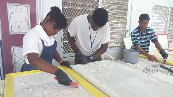 SURFACE PREPARATION - C. I. Gibson seniors, Shaquelle Taylor, Fabian Shepherd and Marchario McDonald are hard at work preparing surfaces for painting. The students attend BTVI twice per week as part of a dual enrollment program. 