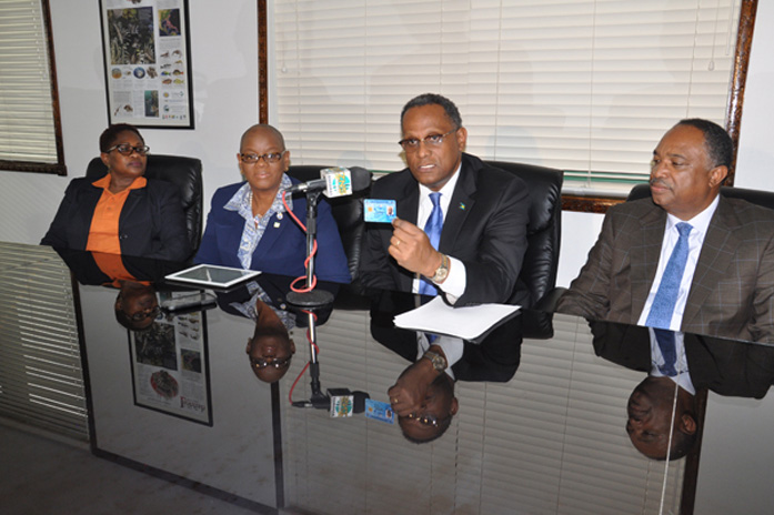 Minister for Grand Bahama, the Hon. Dr. Michael Darville holds up a new NIB smart card. He is encouraging all residents on Grand Bahama, and indeed throughout the country to register for the NIB card. Left to right in the photo are: Rosetta Booth, Chief Operation Manager at NIB’s Freeport office; Cecile Williams-Bethel, Senior Deputy Director of Operations, NIB; Dr. Darville; and Melvin Seymour, Permanent Secretary, Ministry for Grand Bahama. (BIS Photo/Vandyke Hepburn)