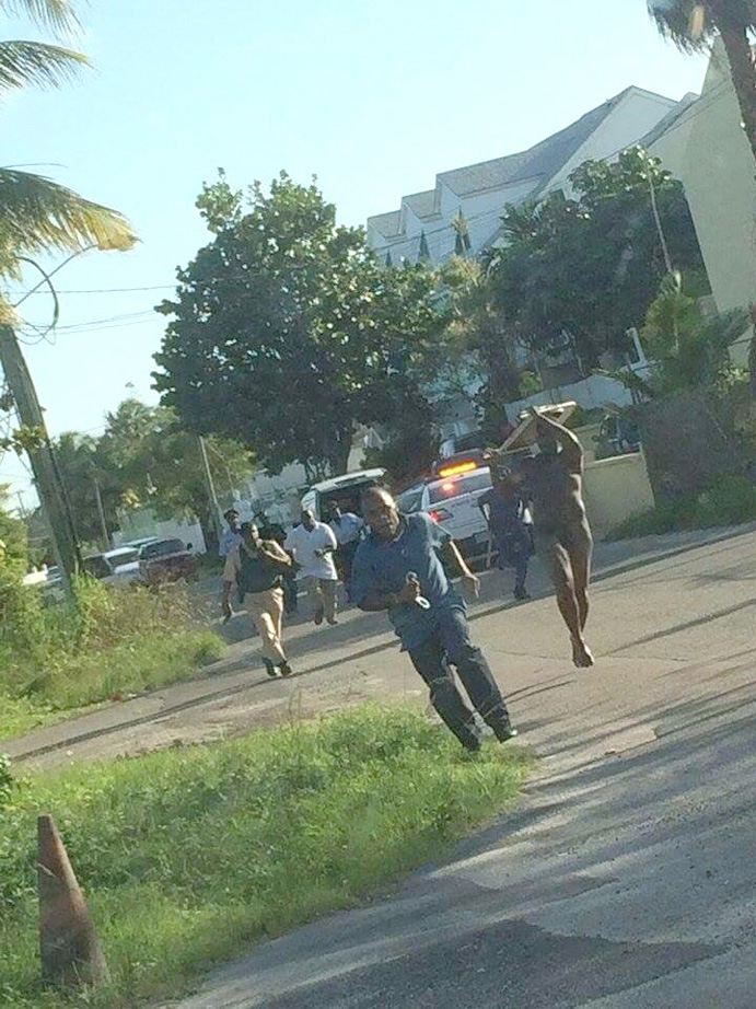 Man chasing police with a chair.