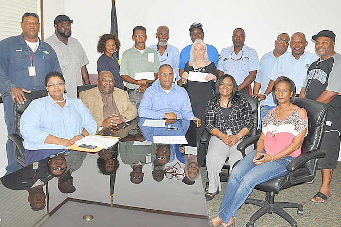 Pictured with the Minister for Grand Bahama Dr. Michael Darville (seated centre) are representatives of the Junkanoo Committee, and groups who received additional seed funding, December 24, 2015 at the Ministry for Grand Bahama. (BIS Photo/Vandyke Hepburn).