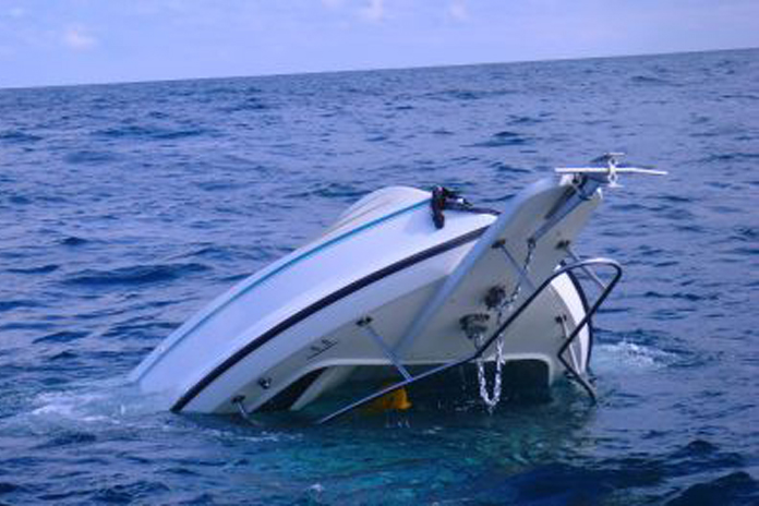 the capsized 21' Pursuit off Holland