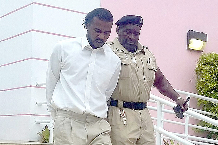 Kenneth George Hart being escorted out of court today by police. Photo by tribune242.com