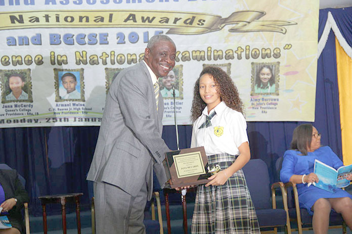 Director of Education, Lionel Sands presents Jana McCardy of Queen’s College with a plaque at the 2015 BJC and BGCSE National Awards Presentation Ceremony.  Ms. McCardy was the 2015 Independent School Candidate with the Best BJC Overall Results.  She received 8As and 1B.  (BIS Photo/Raymond A. Bethel, Sr.)