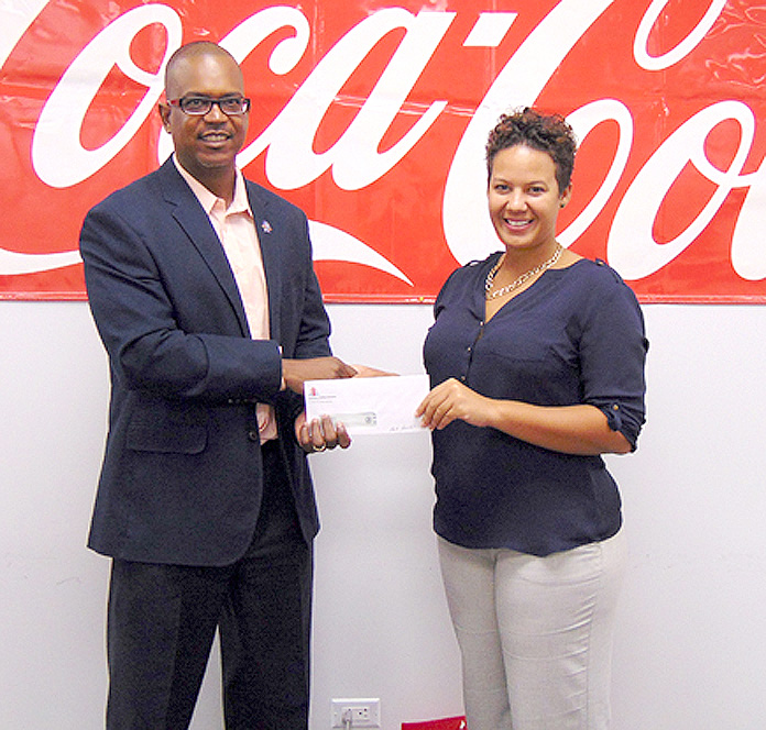 Photo (L-R) Dwayne Swaby, VP of Development - Sunshine Insurance, and Cara Douglas, Marketing Manager - Caribbean Bottling Company. Over the past four consecutive years CBC has donated a total of $20,000 to Marathon Bahamas.