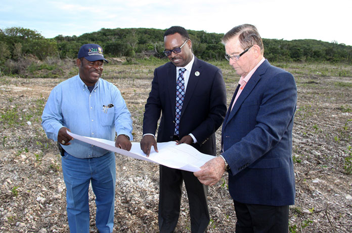 The Hon. Daniel Johnson, Minister of Youth, Sports and Culture (centre) and the Hon. Edison Key, MP for Central and South Abaco look over plans for the Sporting Complex underway in Moore’s Island.
