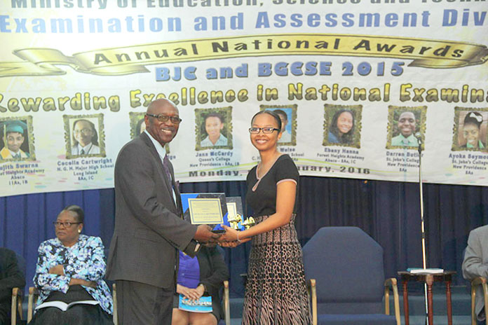 District Superintendent for the Northwest District Howard Newbold, presents Cecelia Cartwright, presently attending The College of The Bahamas and former student of N.G.M. Major High School, Long Island with a plaque at the 2015 BJC and BGCSE National Awards Presentation Ceremony.  Ms. Cartwright had the Best Overall Performance in the 2015 BGCSE Examinations Government Schools.  (BIS Photo/Raymond A. Bethel, Sr.)