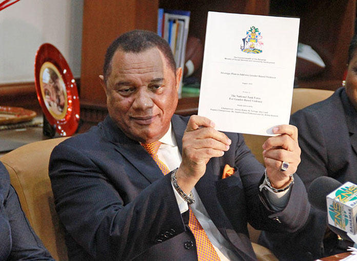 Mr. Christie holding the report that he characterized as "landmark" in nature. (Photo: BIS) 