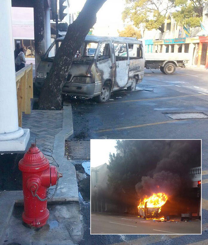 Taxi burst into flames on Bay Street this morning.
