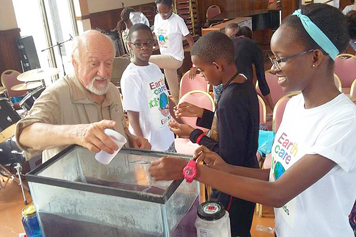 Martin Keeley with the EARTHCARE Eco Kids doing an activity to show the properties of feathers. 