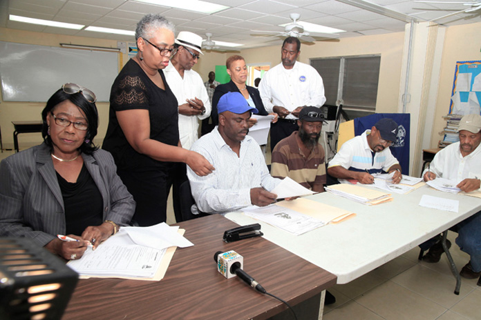 Contracts were signed Thursday, February 25, 2016 in Crooked Island for the repairs to Government buildings damaged by Hurricane Joaquin, which passed through the Central and Southeast Bahamas, October 2015. Pictured from left are Francita Neeley, Island Administrator, Crooked Island; Melanie Roach, the National Repairs and Reconstruction Unit; the Hon. V. Alfred Gray, Minister of Agriculture and Marine Resources and Member of Parliament for MICAL; the Hon. Hope Strachan, Minister of Financial Services and Local Government and Captain Stephen Russell, Director, the National Emergency Management Agency, NEMA. Contractors seated from left are Lorenzo Moss, Whitney Scavella, Clinton Scavella and Ernel Heastie. (BIS Photo/Derek Smith) 