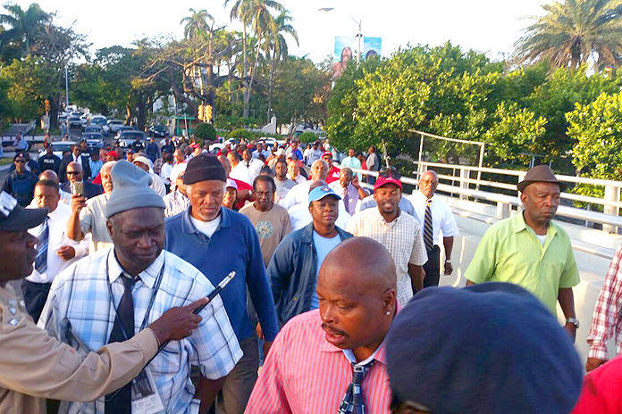 Scores of workers marched with Minnis over the Paradise Island Bridge in protest to the blocking of access to public beach on the island.