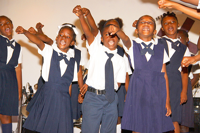 Grades 1 and 2 give a musical tribute to Paul Turnquest, former principal of United Estates Primary School. (BIS Photo/Patrick Hanna) 