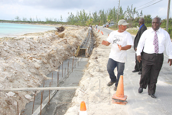 The Hon. Philip Davis, Deputy Prime Minister and Minister of Works and Development, inspects a seawall under construction in San Salvador.  (BIS Photo/Patrick Hanna)