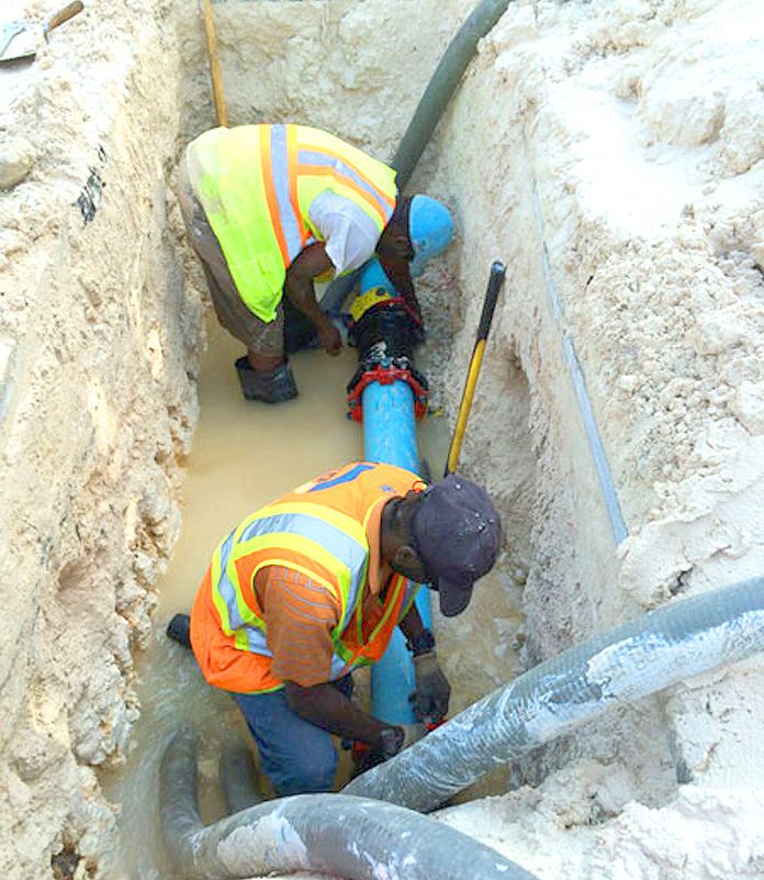 Workers repairing a leak on Blue Hill Road on New Providence. (Photo: WSC/Barefoot Marketing). 
