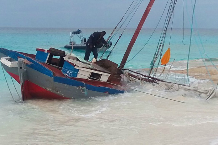 RBDF Marine searches wooden Haitian sailing sloop that beached on Half Moon Cay this morning.