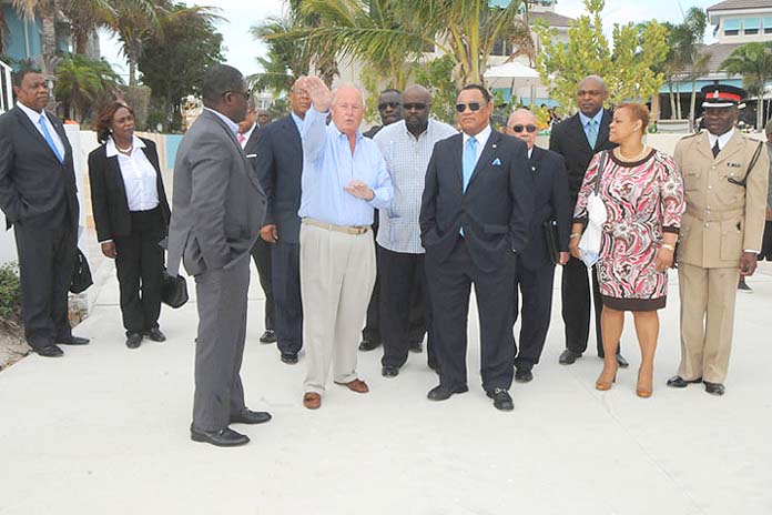 February Point Investor John McGarvey, centre left, directs a tour of the re-developing property with Prime Minister the Rt. Hon. Perry G. Christie, centre right, and Government Ministers Hope Strachan, Kenred Dorsett, Khaalis Rolle, and other officials. (BIS Photo/Peter Ramsay) 