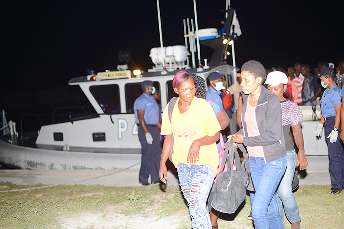 RBDF Marines assist migrants as they disembark HMBS P 44 upon arrival at HMBS Coral Harbour (Photo: Marine Seaman Stefan McDonald)