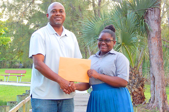 Pictured: Branae Minnis presenting her $2,000.00 Check to Mr. Vandyke Pratt, Foundation Chairman. 