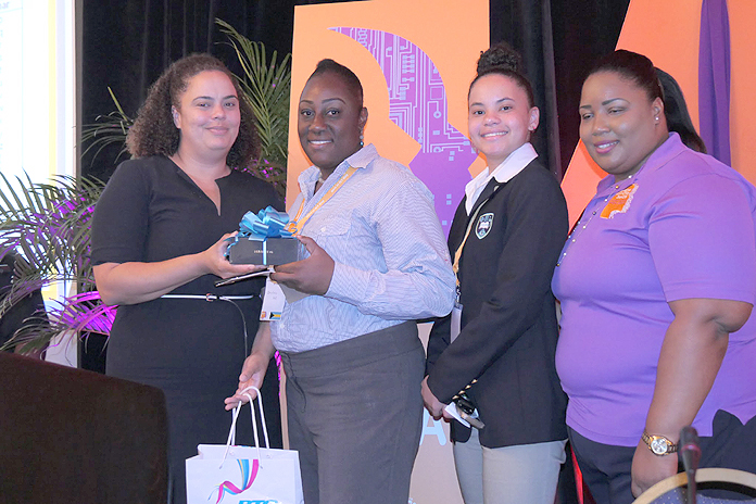 Neisha Butler (VP, Financial Analysis & Planning) presents students with prizes.