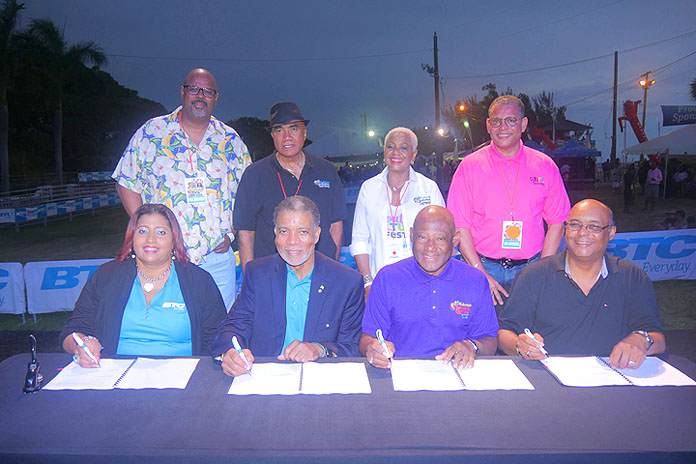 Members of the Carnival Committee sits down with BTC CEO Leon Williams at contract signing.