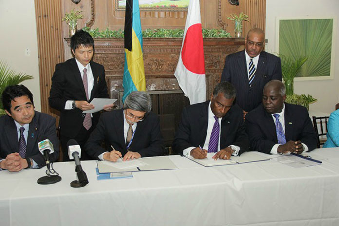 Pictured during the signing, seated from left: Mr. Manabu SAKAI, State Minister of Finance of Japan; Mr. Masanori NAKANO, Ambassador of Japan to the Commonwealth of The Bahamas; the Hon. Fred Mitchell, Minister of Foreign Affairs and Immigration, and the Hon. Philip Davis, Deputy Prime Minister and Minister of Works and Urban Development. Photos BELOW also show parties during handshake and a toast. (BIS Photos/Raymond A. Bethel, Sr.)
