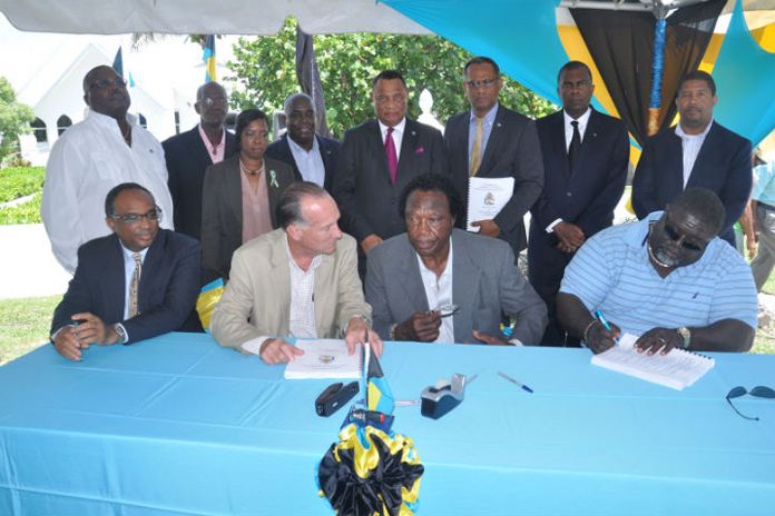 The Bahamas Government signed a contract for the construction of a Seawall in Smith’s Point in Freeport, Grand Bahama, Friday, June 24, 2016. Pictured sitting from left are Melvin Seymour, Permanent Secretary, Ministry for Grand Bahama; Colin Higgs, Permanent Secretary, Ministry of Works and Urban Development; Washington Smith, Owner, Smith’s Construction and Teneil Smith, Smith’s Construction. Standing from left are: Arnold Forbes, Minister of State, Ministry of Works and Urban Development; Clifford Edden, Councillor, Smith’s Point Township; Toni Hudson-Bannister, Assistant Engineer, Ministry of Works and Urban Development; the Hon. Philip Davis, Deputy Prime Minister and Minister of Works and Urban Development; the Rt. Hon. Perry Christie, Prime Minister and Minister of Finance; Dr. the Hon Michael Darville, Minister for Grand Bahama; the Hon. Fred Mitchell, Minister of Foreign Affairs and Immigration; and Peter Turnquest, M.P. East Grand Bahama and Deputy Leader of the Official Opposition, Free National Movement. (BIS Photo/Vandyke Hepburn) 