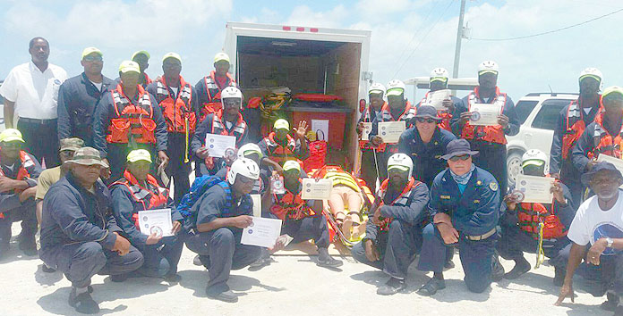 Participants and facilitators pose for a photo at the completion of a Surface Water Rescue Course in Acklins at the Spring Point community centre and surrounding sea, June 20 - 23, 2016. Pictured amongst the participants are Captain John Holland, U.S. Department of Public Health Services; Jeffrey Smith, USNORTHCOM/U.S. Embassy, Nassau; Captain Stephen Russell, Director, NEMA; Police Inspector A. Miller, District Police Chief; and Captain Doug Ebert – U.S. Department of Public Health Services and Luke Bethel, training officer, NEMA.  (BIS Photo/Lindsay Thompson)