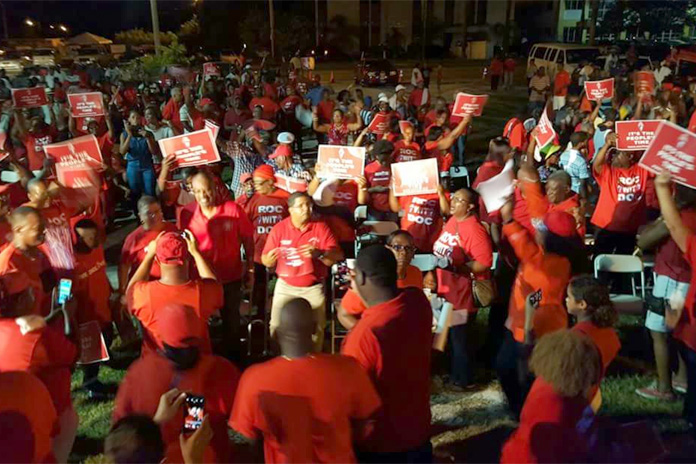 Dr. Hubert Minnis and Deputy Leader Peter Turnquest flanked by supporters tonight on Grand Bahamas.