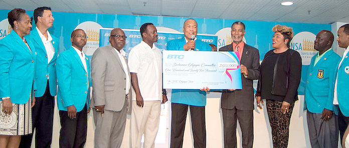 BTC Supports National Rio Olympic Team – Bahamas Olympic Committee President Wellington Miller (centre) receives a cheque for $125,000 to support the national Olympic team from Leon Williams, CEO of Bahamas Telecommunications Company, the team’s major sponsor. Looking on is Minister of Youth, Sports & Culture Hon. Dr. Daniel Johnson MP (5th from left) and Team Chef de Mission Roy Colebrook (2nd from right) together with Olympic and BTC officials. BOC photo-Kevin Major
