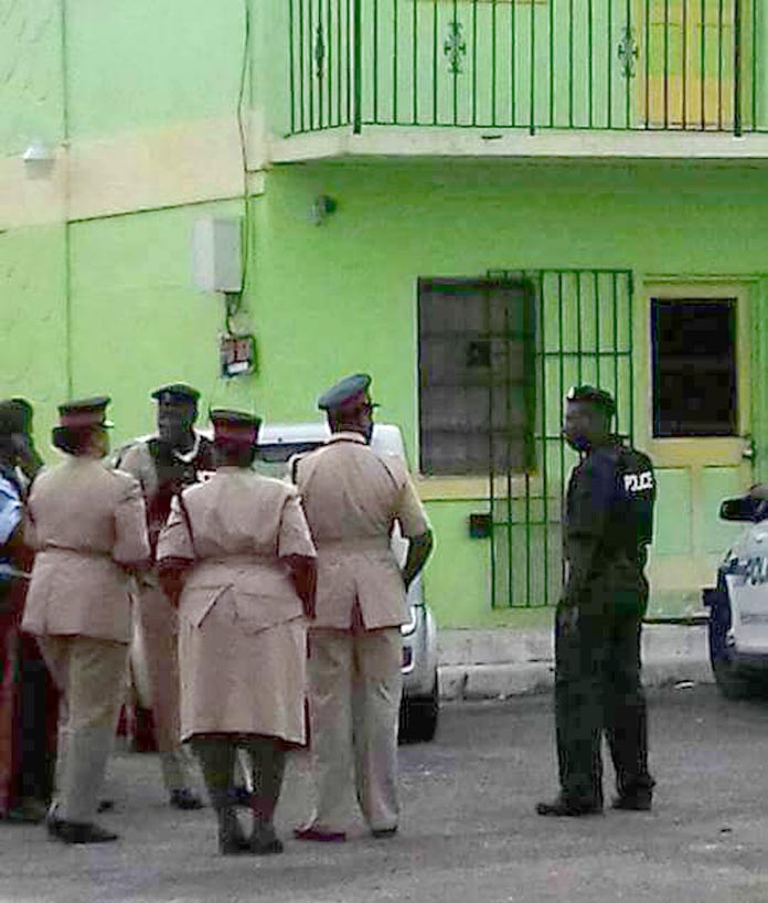 Police outside the apartment complex where a female educator has been found dead this morning.