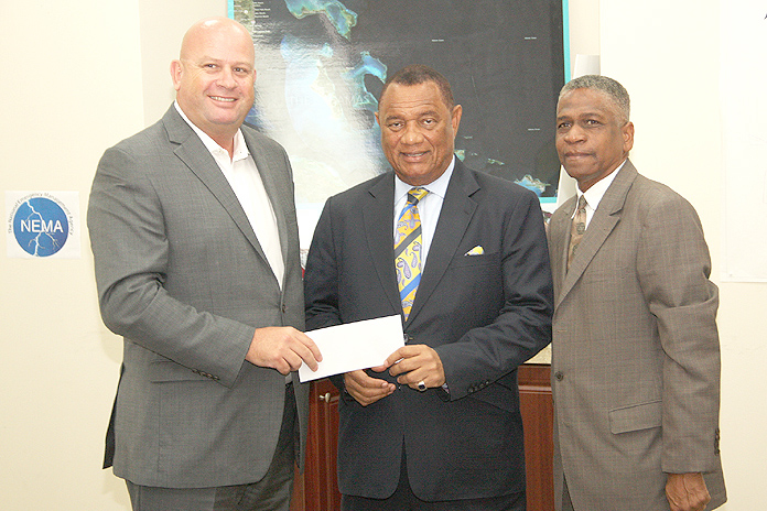 Exuma Developer $25,000 Donation – Children’s Bay Cay and Williams Cay Project Manager Michel Neutelings, left, presents a cheque for $25,000 to Perry G. Christie, Prime Minister of The Bahamas, on behalf of developer Dona Bertarelli to assist with hurricane relief following the passage of Hurricane Matthew. On hand and assisting with the donation was Jack Thompson, Permanent Secretary, Office of the Prime Minister. Funds are earmarked for the National Reconstruction and Disaster Committee and for Rotary to supply survival kits. (Photo: Patrick Hanna, BIS) 