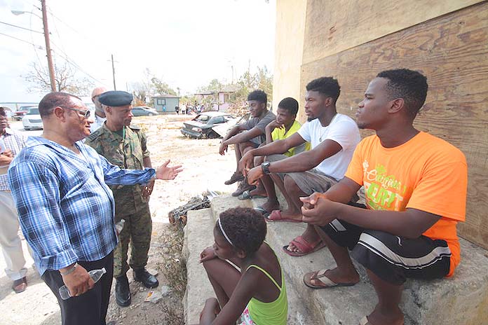 Prime Minister the Rt Hon Perry Christie speaks with young people, whose homes were severely damaged during the passage Hurricane Matthew. The Prime Minister, Director of NEMA Captain Stephen Russell, and other high-ranking officials carried out an assessment on Saturday, October 8, 2016 to Lowe Sound, Andros and West End, Grand Bahama the areas hardest hit by the storm. (BIS Photo/Eric Rose)