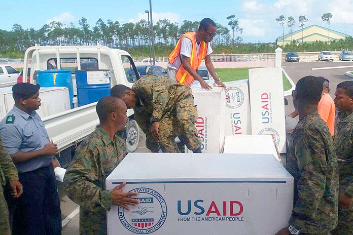 Royal Bahamas Defence Force marines loading tarpaulin on the back of trucks for distribution to residents in New Providence, who suffered roof damages during the passage of Hurricane Matthew last week. (PHOTO/NEMA)