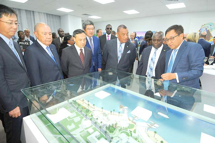 Prime Minister the Rt. Hon. Perry Christie, centre right, and DEPUTY PRIME MINISTER Philip Brave Davis review an architectural rendering of The Pointe, downtown, with investors and officials.  (BIS Photo/Peter Ramsay)
